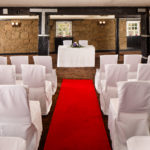 The Brasserie at Mercure Perth Hotel set up for a wedding ceremony, red carpet, white chair covers