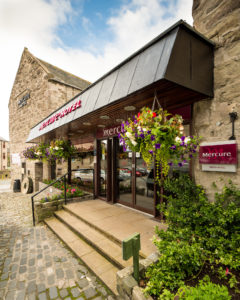 Exterior shot of Mercure Perth Hotel, hanging baskets of flowers outside