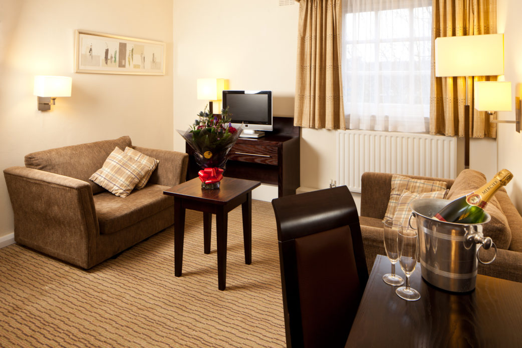 Superior bedroom seating area at Mercure Perth Hotel, champagne and flowers