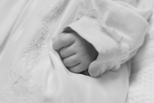 Young girl child on her Baptism day, sometimes called Christening. An important family celebration.