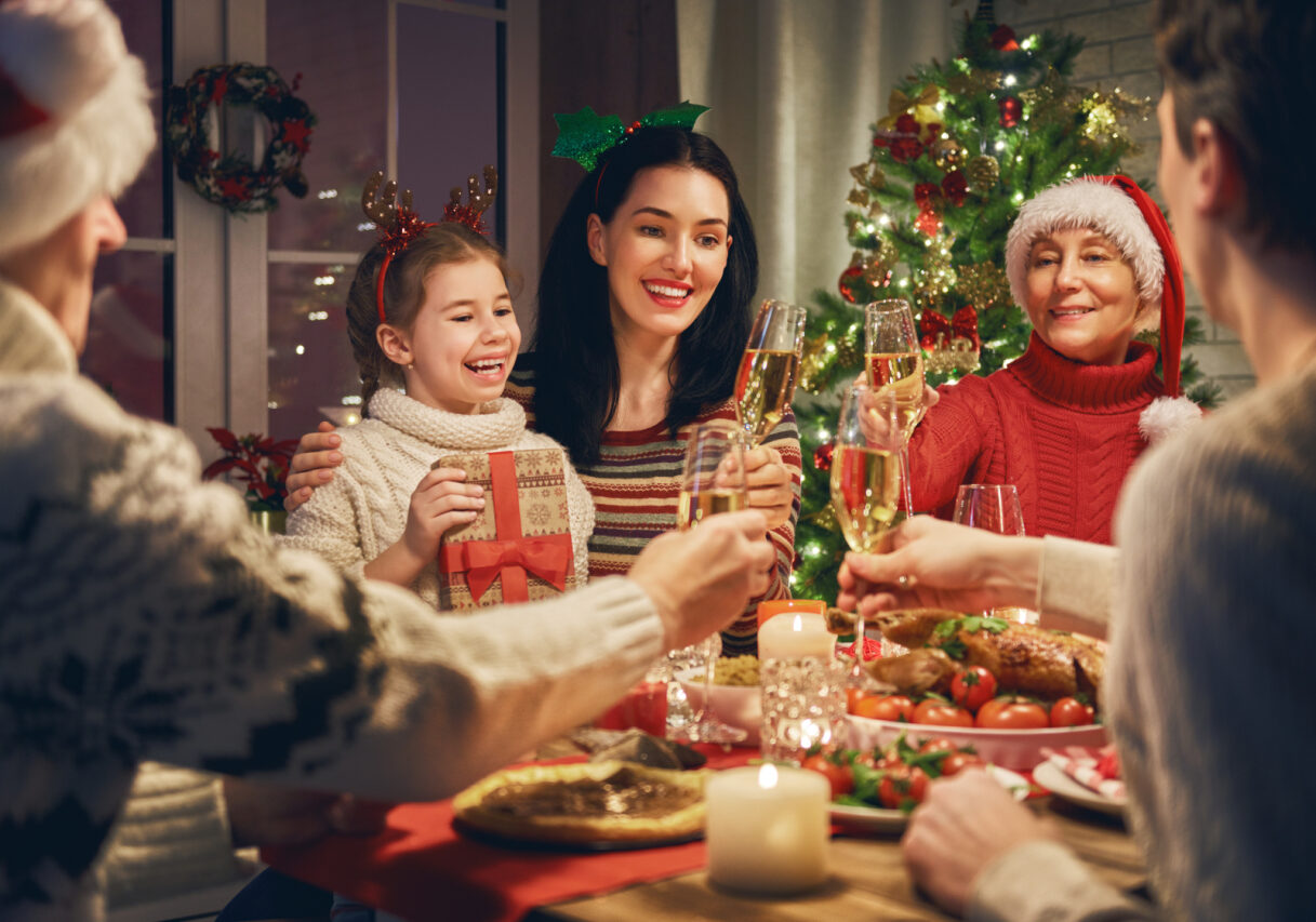 Merry,Christmas!,Happy,Family,Are,Having,Dinner,At,Home.,Celebration table with wine glasses